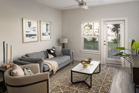 a living room with a gray couch and a coffee table